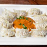 Chicken Momo (8Pcs) · Wrapper filled with ground meat and vegetables (onion, cilantro, green onions, cabbage, caul...