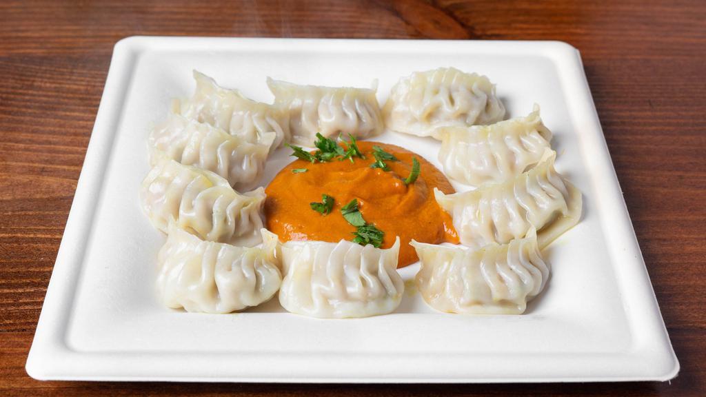 Chicken Momo (8Pcs) · Wrapper filled with ground meat and vegetables (onion, cilantro, green onions, cabbage, cauliflower, soy chunk, ginger and garlic) seasoned with salt and spices the steamed to perfection. Served with our Momo sauce. Side of Asian slaw or rice.