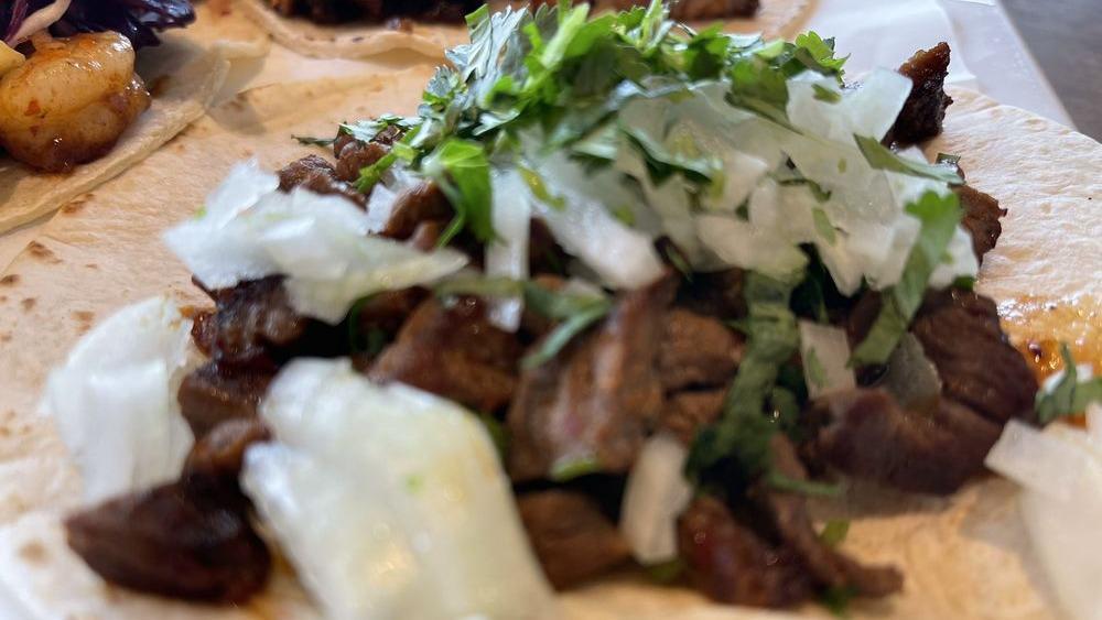 Bistec · 3 pieces. Grilled steak tacos topped with onions and chopped cilantro. 
Warning: consuming raw or uncooked foods such as meat, poultry, seafood, shellfish or eggs may increase your risk of food borne illness.