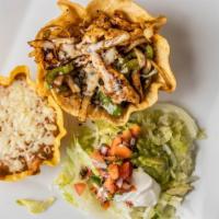 Taco Loco · Crispy flour shell filled with steak or chicken cooked with onions, tomatoes and peppers. Se...