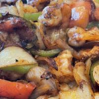Fajitas · Choice of steak or chicken. Grilled with onions, peppers and tomatoes. Served with rice, bea...