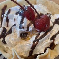 Fried Ice Cream · Vanilla ice cream With a crispy coating, topped With whipped cream, chocolate sauce and a ch...