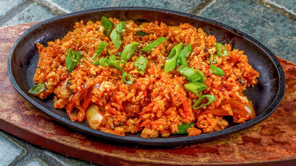 Kimchi Fried Rice · Spicy. Stir fry carrots, kimchi, onions, bell peppers, mushrooms, egg, and rice. Topped with green onions.