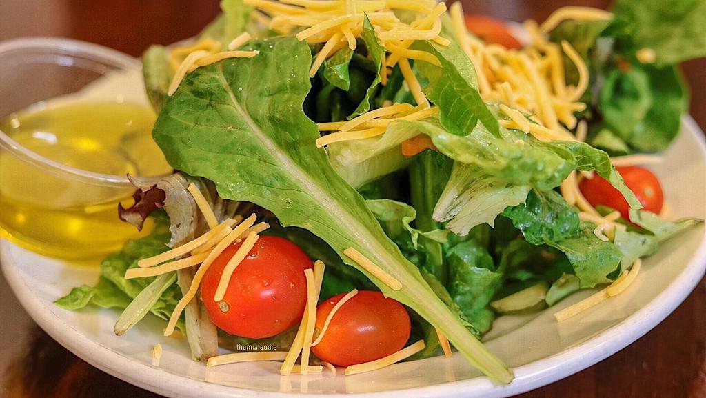 House Salad · Romaine lettuce, spring mix blend, tomatoes, cucumbers, sweet peppers, red onions, topped with cheese and croutons.