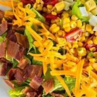 Cobb Salad · Crisp romaine lettuce, crumbled bacon, chopped egg, tomato & corn relish, cheddar cheese, an...