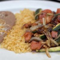 Pollo Asado · Char-grilled chicken breast, sautéed vegetable medley, Mexican rice and refried beans.