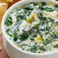 Spinach Dip · Creamy blend of spinach, topped with parmesan cheese and served warm with crisp tortilla chi...