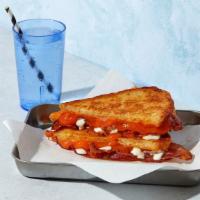 The Bacon Cheddar Ranch · Melted Cheddar cheese with bacon and ranch grilled between two slices of buttered bread.