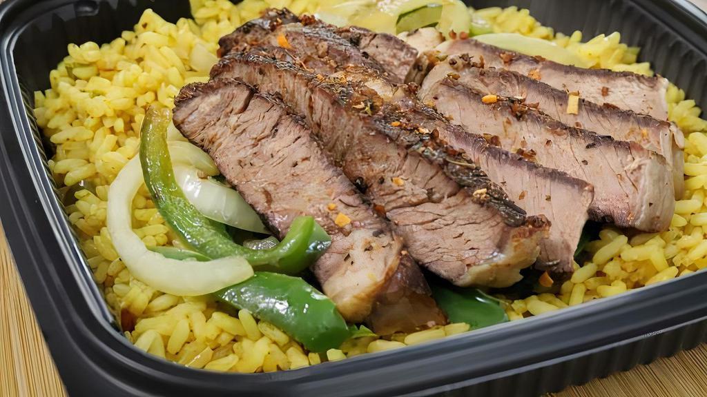 Pepper Steak Rice · Air-fried ribeye to sautéed green peppers served with steamy rice pilaf and gravy.