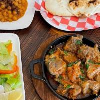 Lamb Karahi · Lamb cooked in pan with green chili tomato's garlic and spices. served with chickpeas, salad...