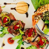 Surf And Turf · Grilled lobster, NY strip, shrimp tempura, spicy tuna, baby arugula. This item contains raw ...