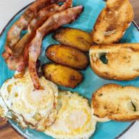 The Conquistador · Eggs (scrambled or fried), choice if meat (ham, turkey bacon), maduros, pressed sobao toast.