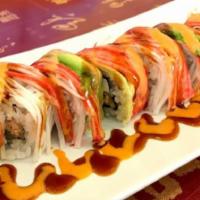 Asian Pot Roll · Salmon with tuna and cream cheese inside, crab meat, and avocado on the top with sauce.