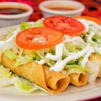 Flautas De Pollo · 5 lightly fried tortillas rolled with chicken toppped with lettuce, red salsa, sour cream an...