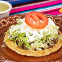 Sopes · Home made thick tortilla fried topped with beans, your choice of meat or veggie (from the gu...