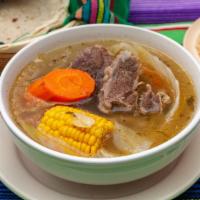 Caldo De Res (Mexican Beef Stew) · Mexican Beef stew with carrots, squash, zuccini, corn and chayote served with a side of rice