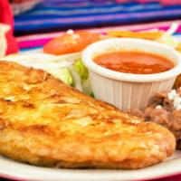 Chiles Rellenos · Poblano Pepper stuffed with cheese lightly fried with egg mix on the outside served with a s...