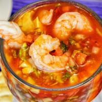 Cocktail De Camarón (Shrimp Cocktail) · Shrimp served in a cocktail sauce with chopped tomatoes, onions,Serrano peppers, avocado, ci...
