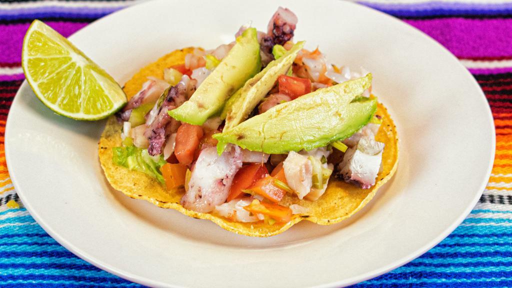 Tostada De Ceviche · Pulpo (octopus), camarón (shrimp) or Pescado (fish). Marinated with lemon juice, mixed with tomatoe, onion, cilantro, and avocado served on top of a crunchy tortilla .