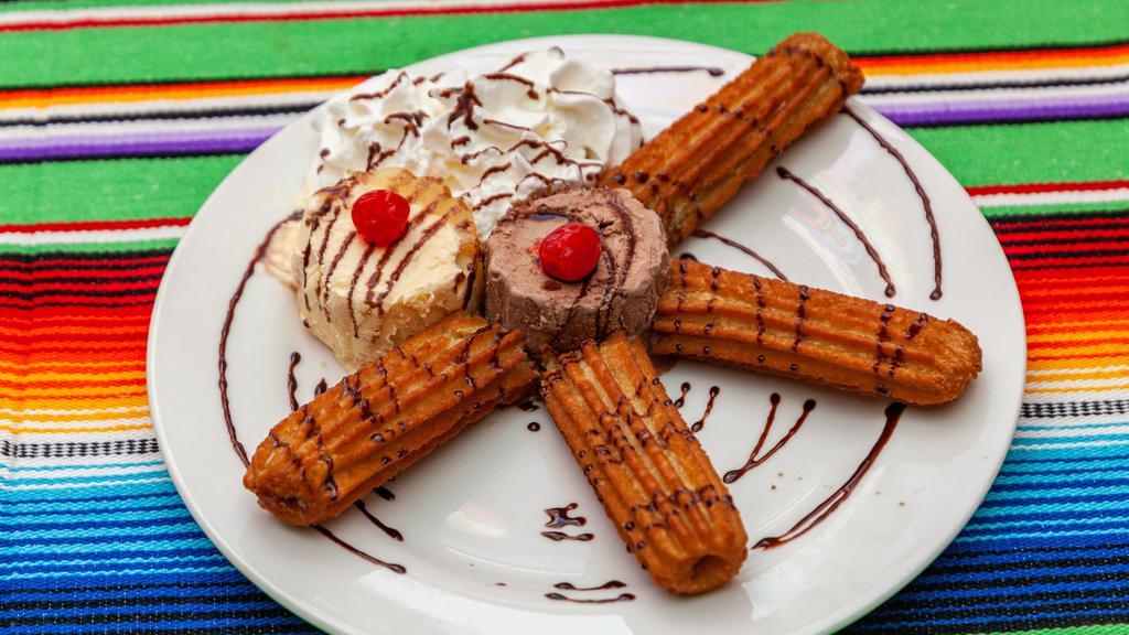 Churros · Two churros served with vanilla icecream and whipped cream