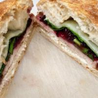 Turkey Berry · Roasted turkey breast on ciabatta bread with mayo, provolone, leaf spinach. With homemade cr...