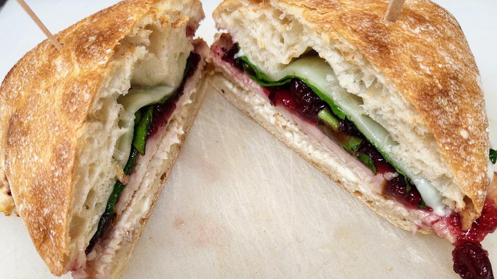 Turkey Berry · Roasted turkey breast on ciabatta bread with mayo, provolone, leaf spinach. With homemade cranberry sauce.