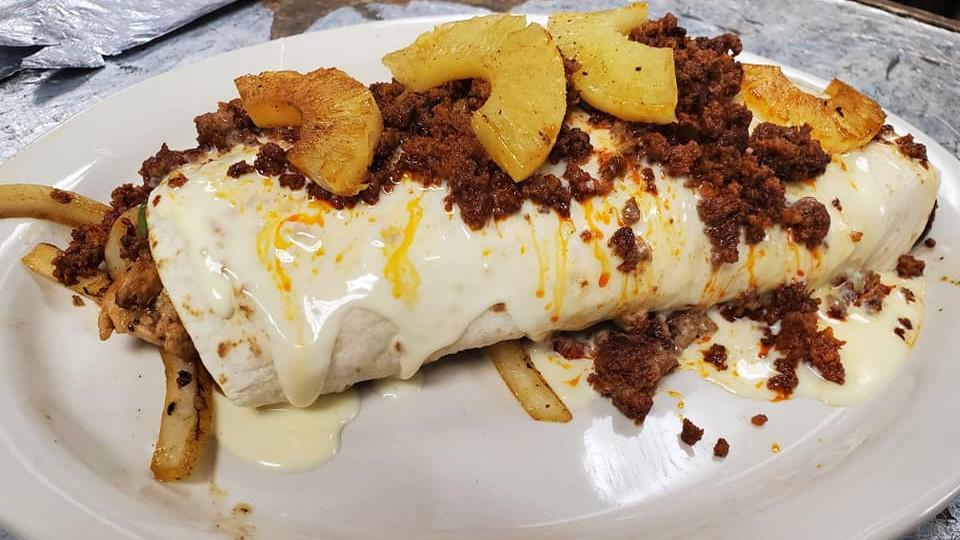 Burrito Hawaiiano · A flour tortilla filled with grilled chicken, steak, shrimp, bell peppers, and onions topped with cheese dip, grilled pineapple, and chorizo (Mexican sausage).