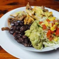 Las Carnitas · Pork tips with rice, beans, pico de gallo, guacamole salad, frijoles charros and jalapeño.