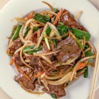 Mongolian Beef · Marinated beef cooked with fresh garlic and green onions, black fungus. In hot and spicy gar...