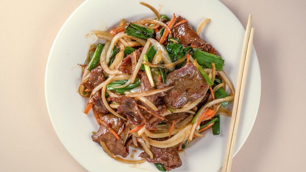 Mongolian Beef · Marinated beef cooked with fresh garlic and green onions, black fungus. In hot and spicy garlic sauce.