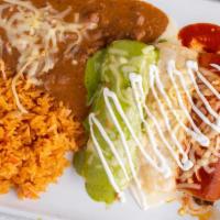 Enchiladas Bandera · Three corn tortillas, one with chicken, one with beef, and one with cheese. Topped with thre...