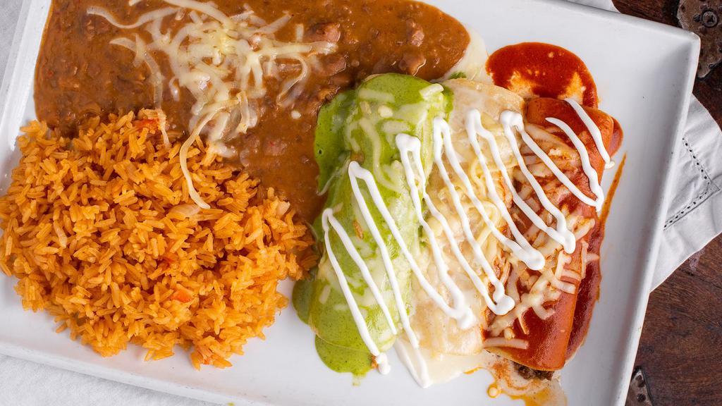 Enchiladas Bandera · (STARTS AT 930 CAL)
Three corn tortillas, one with chicken, one with
beef and one with cheese. Topped with three
different sauces and queso fresco. Served with a
side of rice and beans.