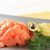 Salmon Tataki · Seaweed salad, salmon and masago with hot sauce.