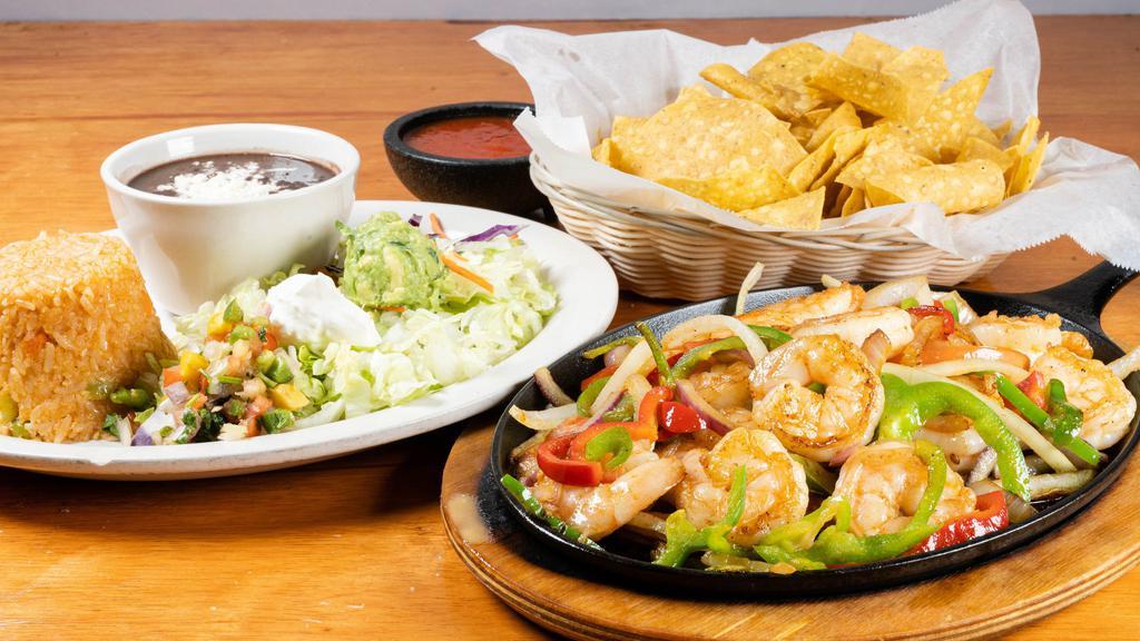 Shrimp Fajitas · Grilled shrimp with tomatoes, bell peppers, and onions. Served with rice and beans.