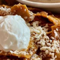 Chilaquiles Mexicanos · Corn tortilla stuffed with chunks of chicken, rice, beans, and our own special sauce.