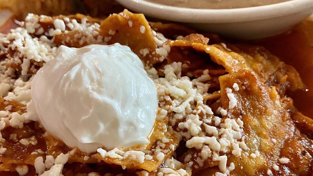 Chilaquiles Mexicanos · Corn tortilla stuffed with chunks of chicken, rice, beans, and our own special sauce.