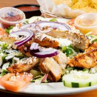 Chicken Fajita Salad · Grilled chicken with onions, bell peppers, tomatoes and cucumbers on a bed of lettuce, toppe...