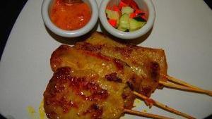 Chicken Satay · Marinated with herbs and spices, grilled on skewers. Served with peanut sauce and cucumber salad.