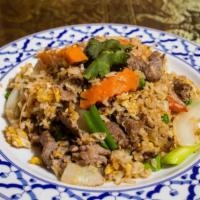Fried Rice · Thai fried rice with eggs, onion, carrot, and green pea.