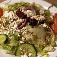 Greek Salad · Spring mix, tomatoes, onions, green peppers, black olives, pepperoncini, feta cheese, and Gr...