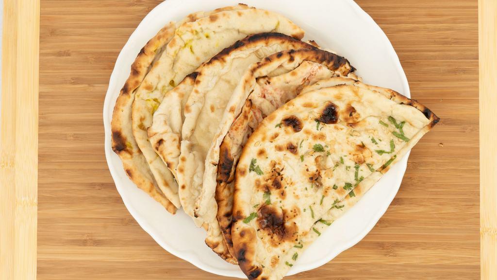 Zayka Bread Basket · Assortment consisting of onion kulcha, garlic naan, butter naan and Kashmiri naan.