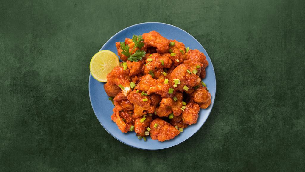 Cauli Manchurian · Fried cauliflower florets sauteed with onions, ginger, garlic, bell peppers and tossed in a chef-special Manchurian sauce.