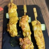 Chicken Satay Skewers (4 Count) · Skewered chicken thigh, yellow curry coconut marinade, cucumber shallot vinaigrette