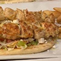 Chicken Souvlaki · Served on top grilled pita, shredded lettuce, tomatoes, onions, and crumbled feta cheese. Se...