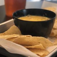 Chips & Queso · Tortilla chips are served with melted cheddar cheese blended with our house made pico de gal...