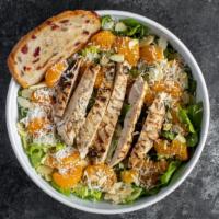 Tropical Grilled Chicken Salad · Romaine lettuce is topped with sweet mandarin oranges, sliced almonds, grilled chicken, toas...