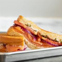 Smoked Salmon · Sourdough bread is loaded with smoked salmon, sliced tomatoes, red onion slices, capers, and...