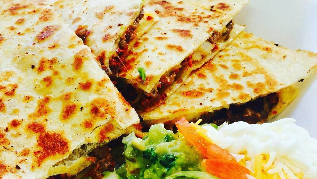 Quesadilla Fajito · A flour tortilla stuffed with chicken or steak grilled with peppers, onions, and cheese.