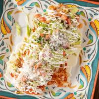 Burrito Grande · A large flour tortillas filled with ground beef or shredded chicken, rice, beans, covered in...