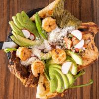 Molcajete · A grilled chicken breast, a piece of carne asada, chorizo with nopales, spring onions, banan...